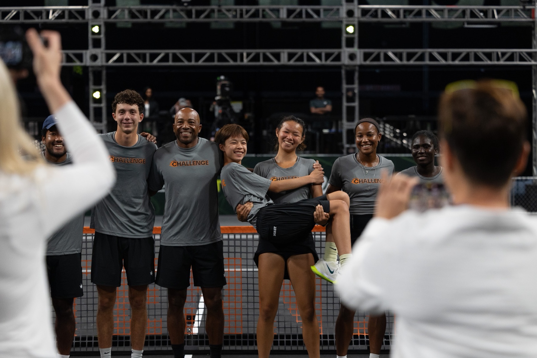 The Challenge Team gathered at the net in grey Challenge shirts.